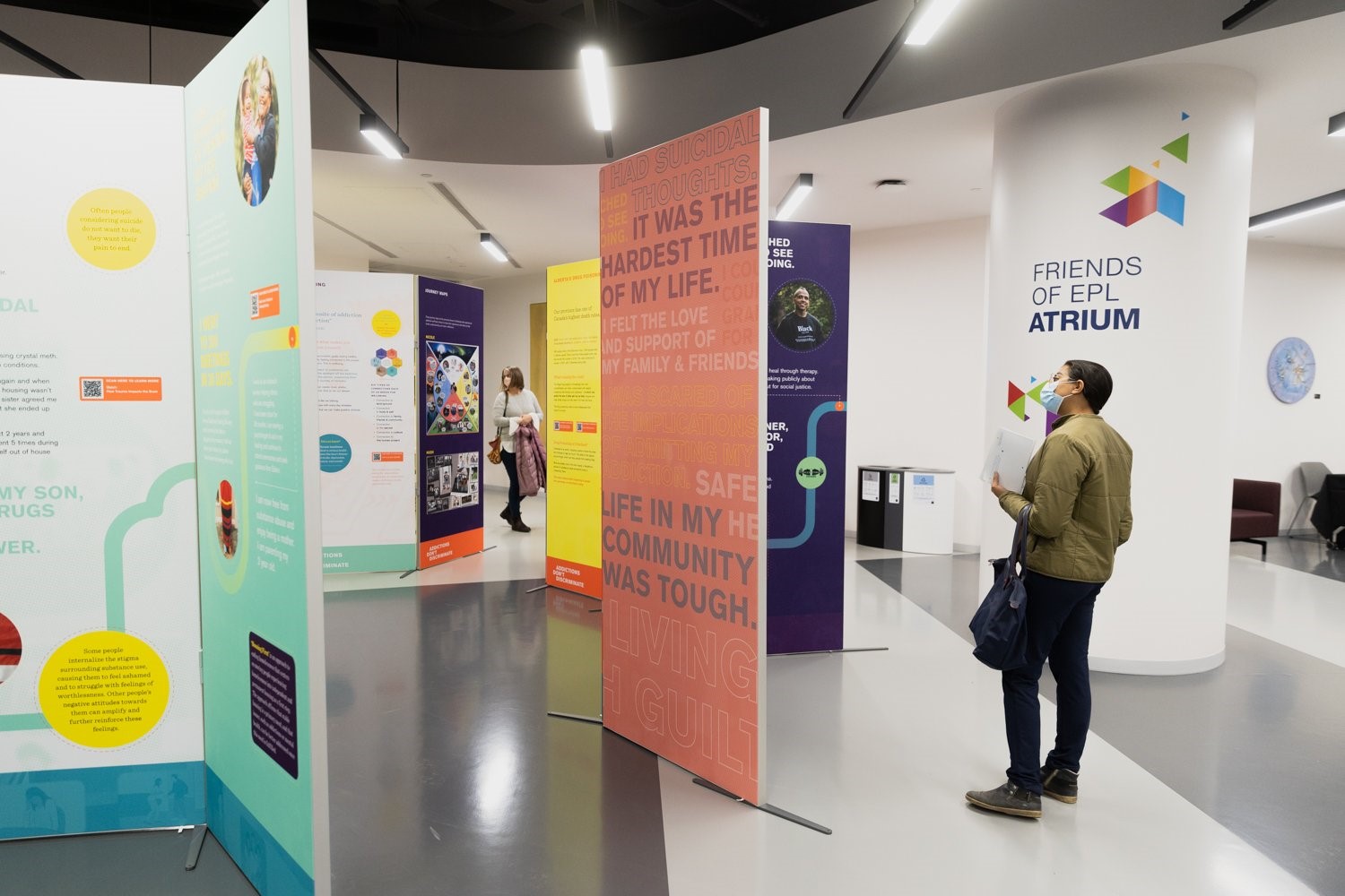 Exhibition with colourful hanging panels.